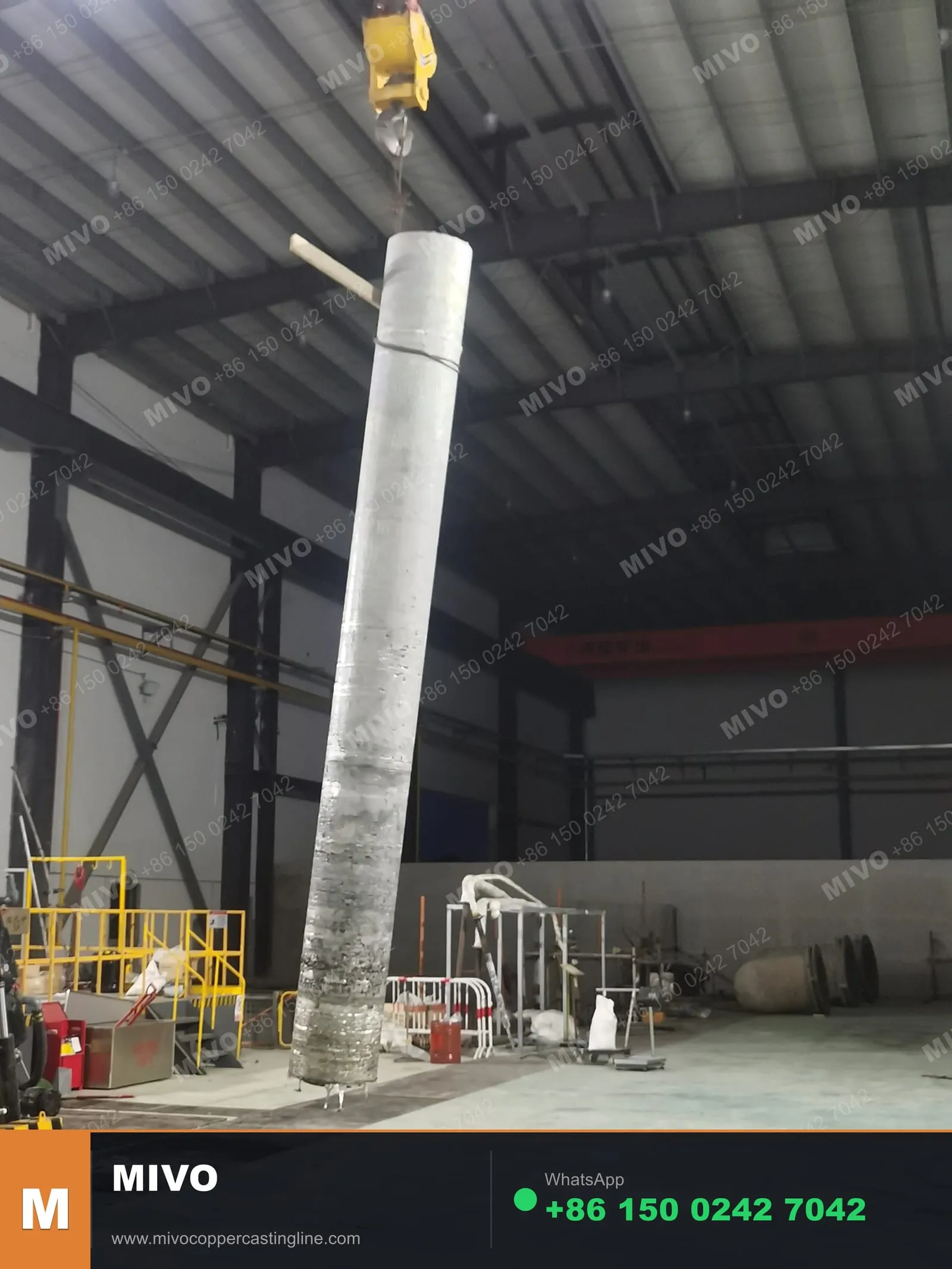 Semi-continuous vertical casting — copper billet emerging from mold